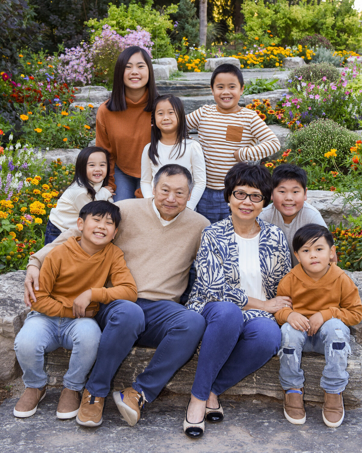 granparents sitting on outdoor steps with grandchildren