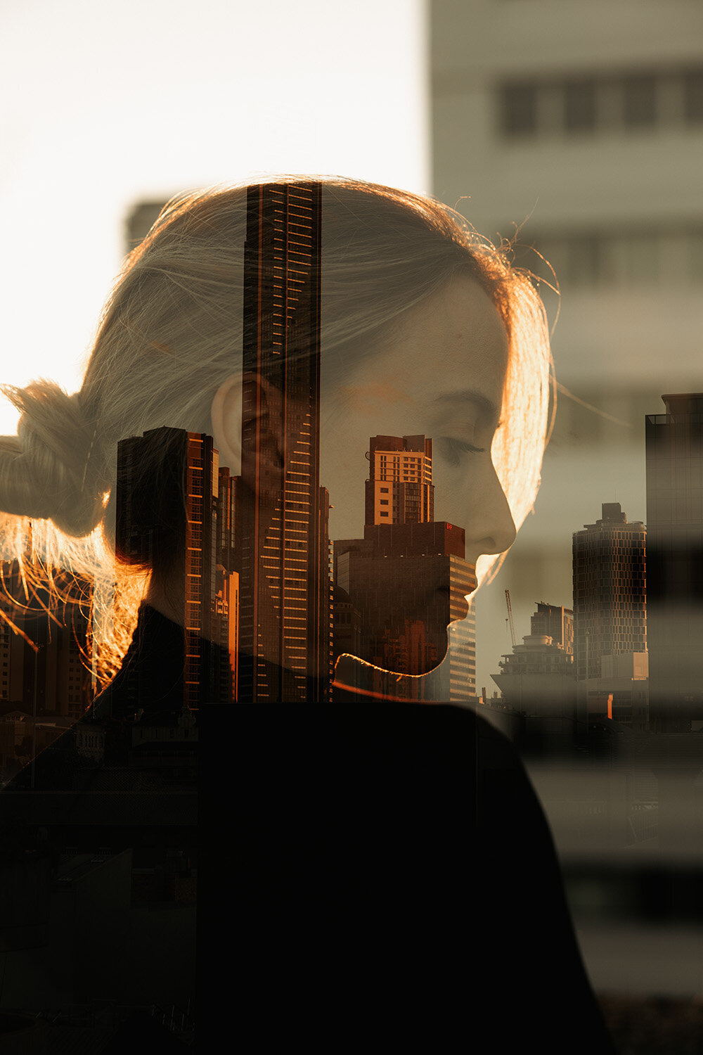 A Sunshine Coast branding photographer explores layered identity with a double exposure portrait merging city skyline and subject.