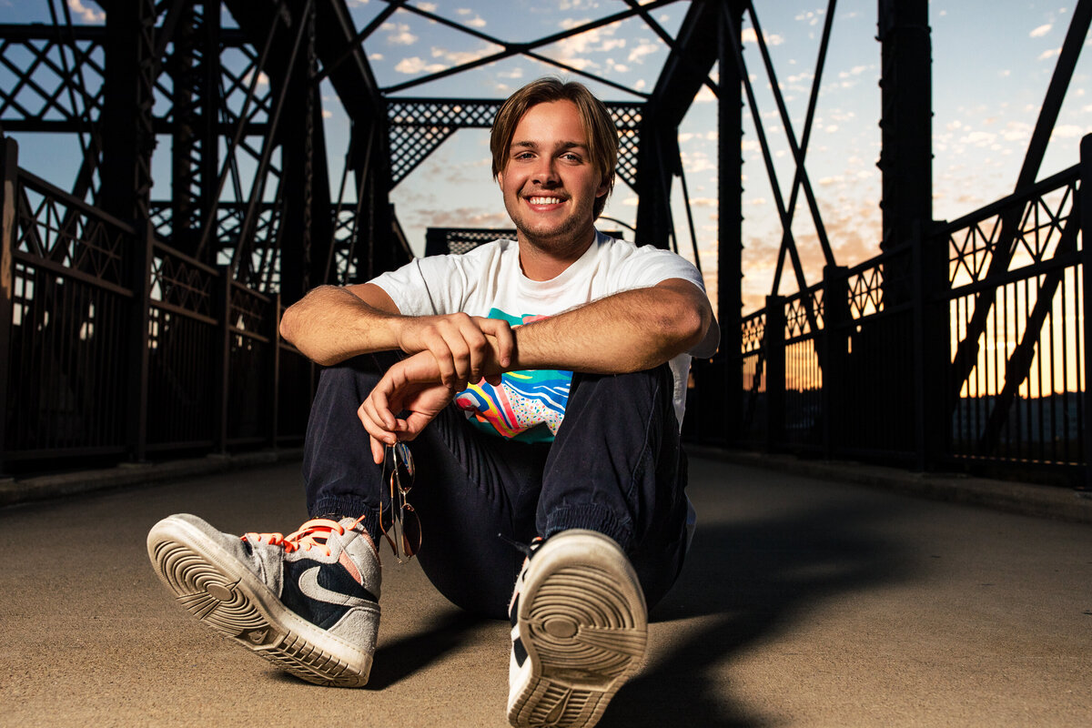 Senior photo session Pittsburgh PA with a teen boy in a casual fall outfit on the hot Metal bridge.