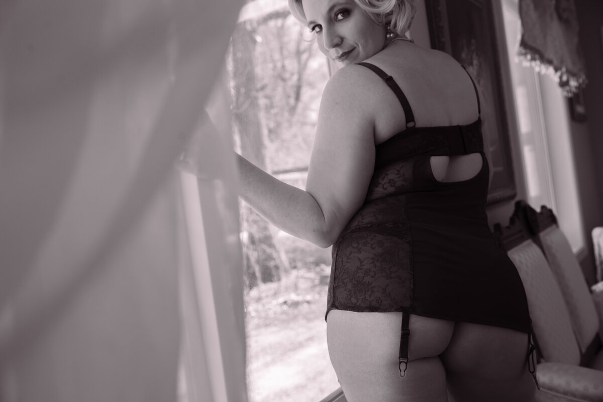 goddess studio boudoir woman black and white sensual through the curtain peekaboo