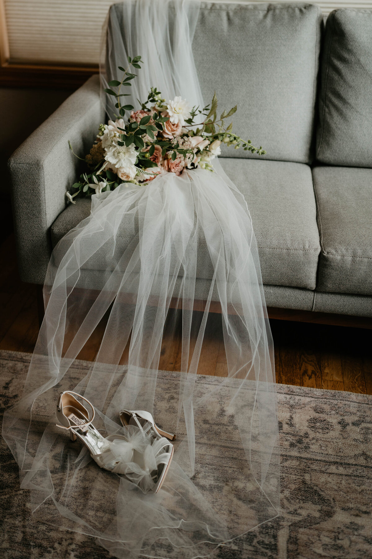 Bridal viel, shoes and flowers on a couch from a Willamette Valley vineyard wedding