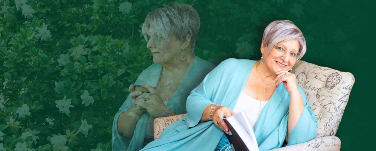 April in a chair holding her book with a collage of her and flowers in the background
