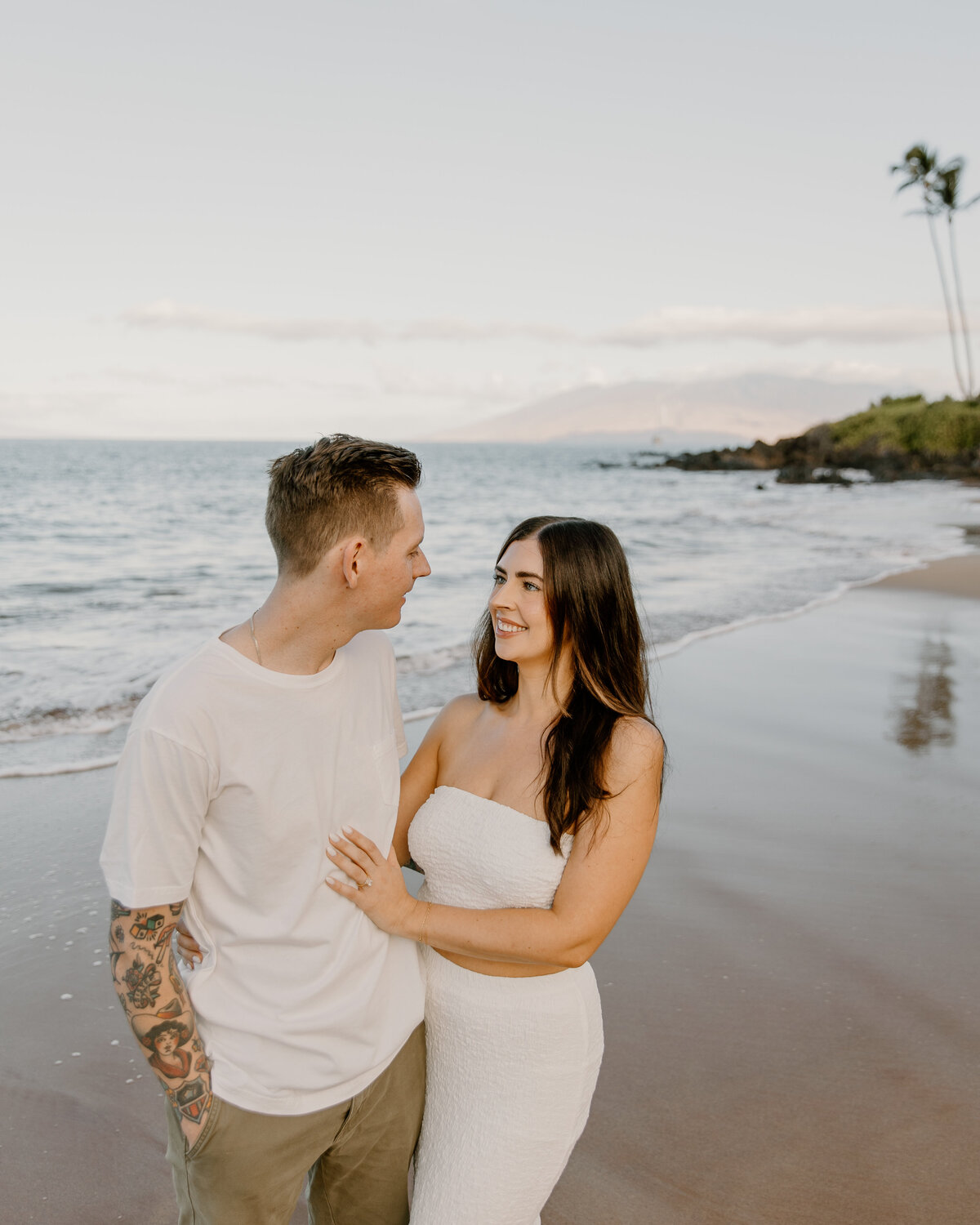 Hawaii Engagement Photographer captures man and woman looking at one another and smiling