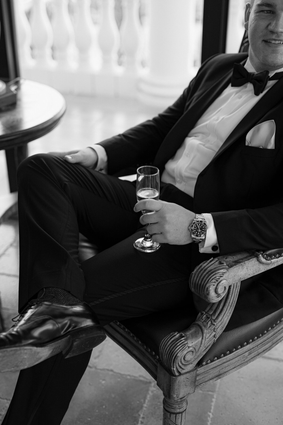 Groom portraits with drink at La Casa Toscana wedding venue