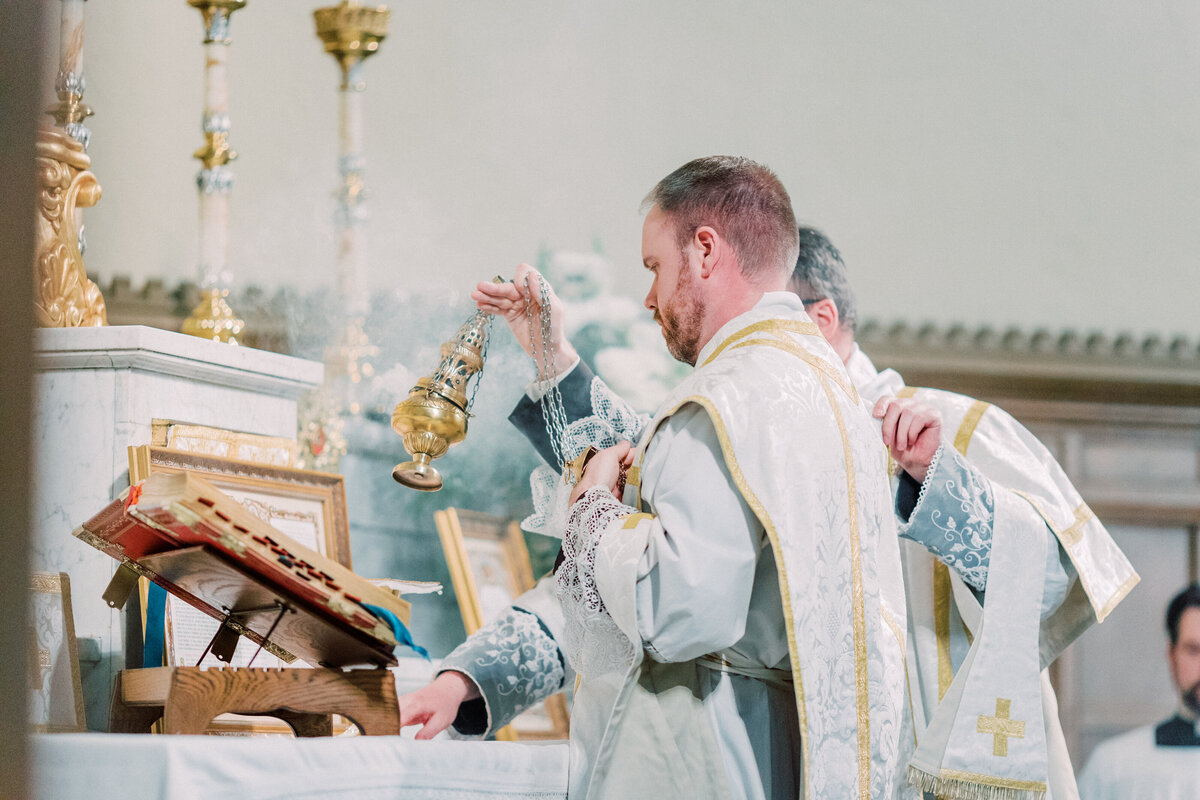Priest swinging Thurible during Catholic Latin Mass wedding at Most Precious Blood Catholic Church in Pittsburgh