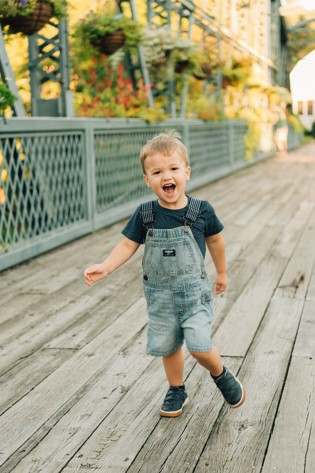 Little boy running on bridge