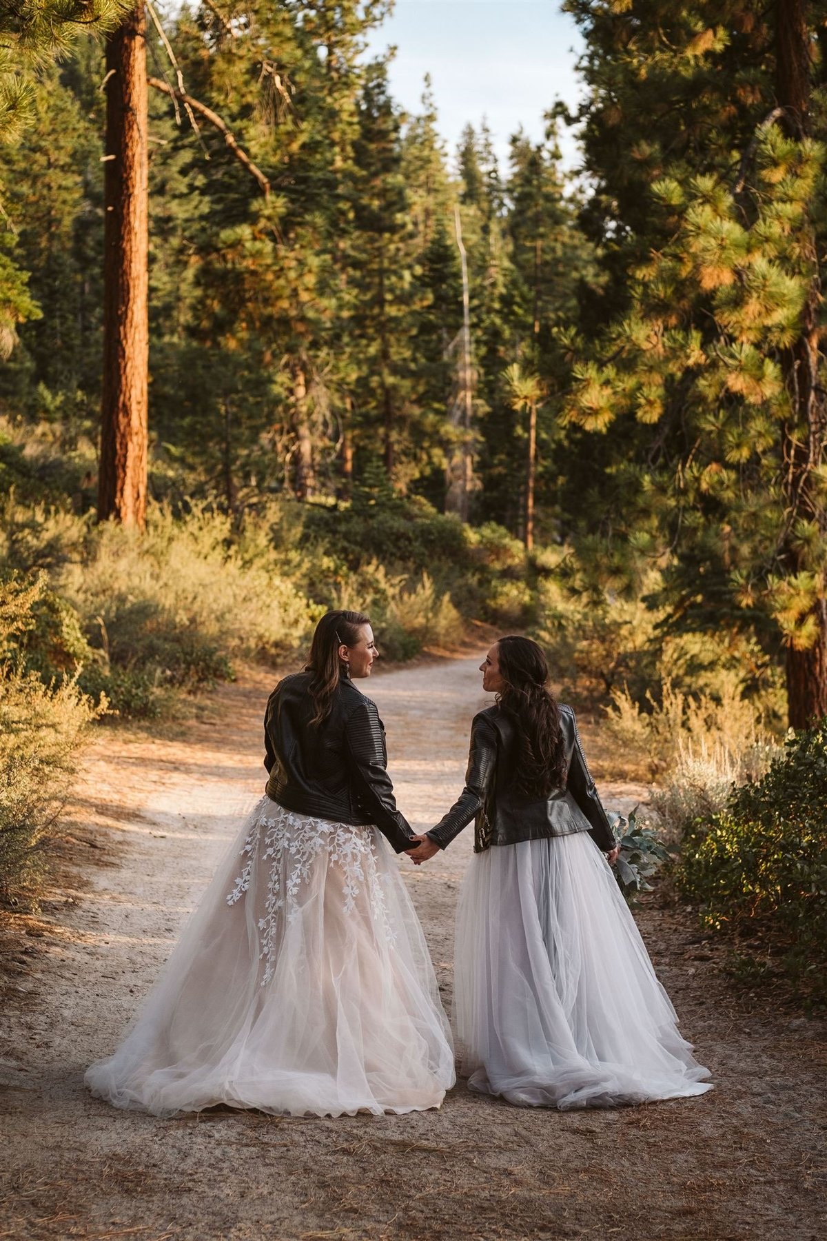 Two brides taking a stroll in the forest
