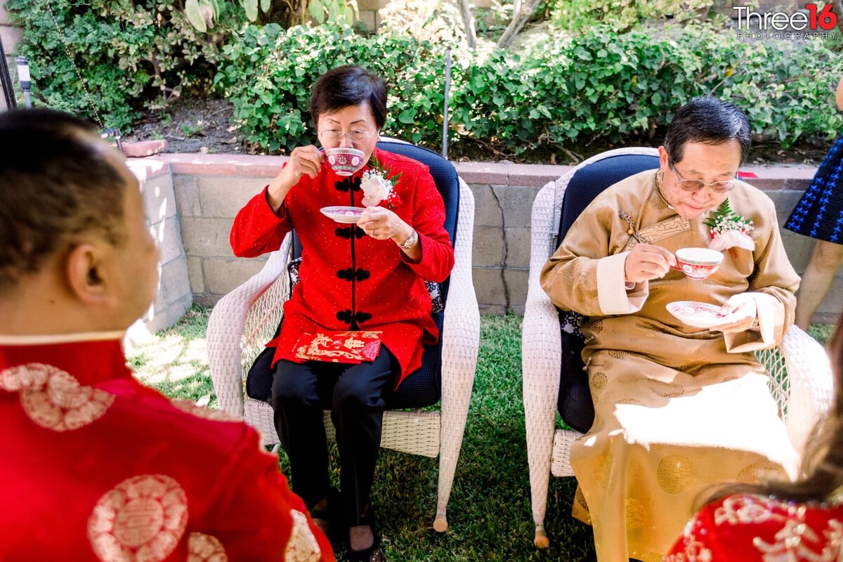 Parents partake in the Chinese Tea Ceremony as the Groom looks on