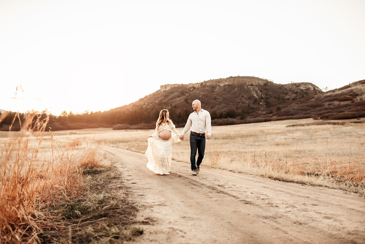 husband and wife walking down dirt road