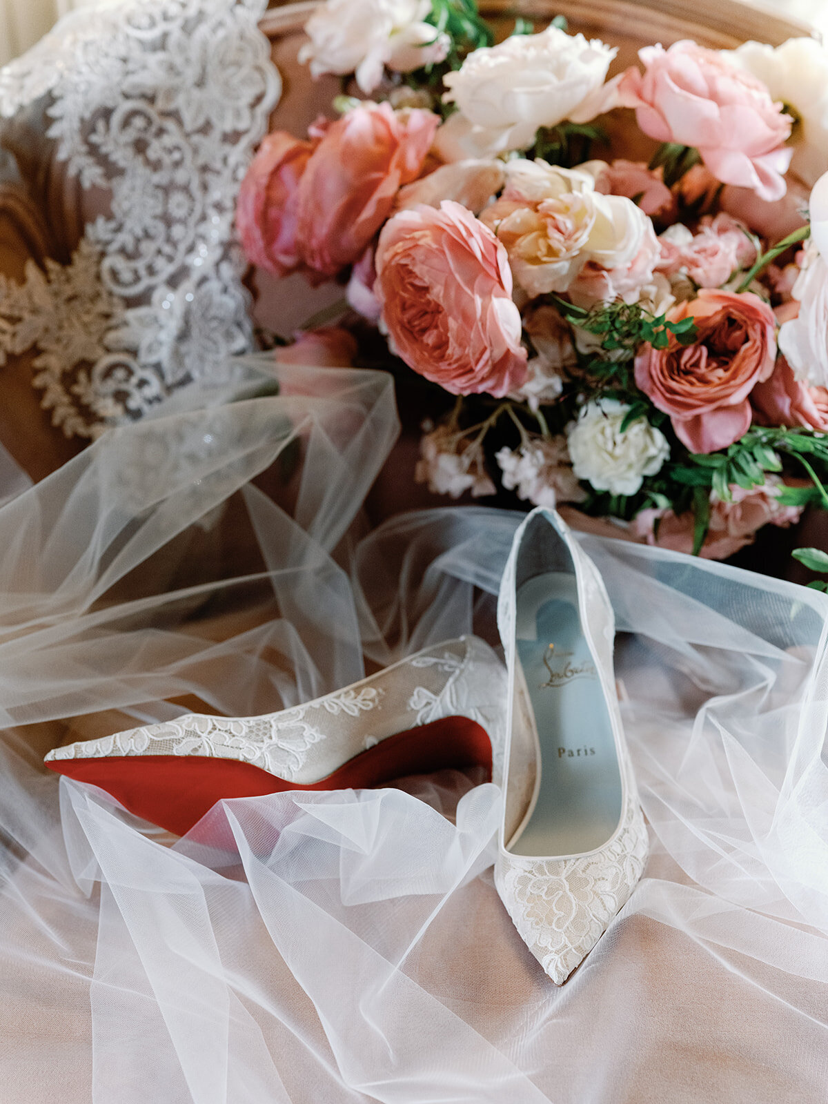 Bouquet, veil and shoes of bridel sitting on a chair