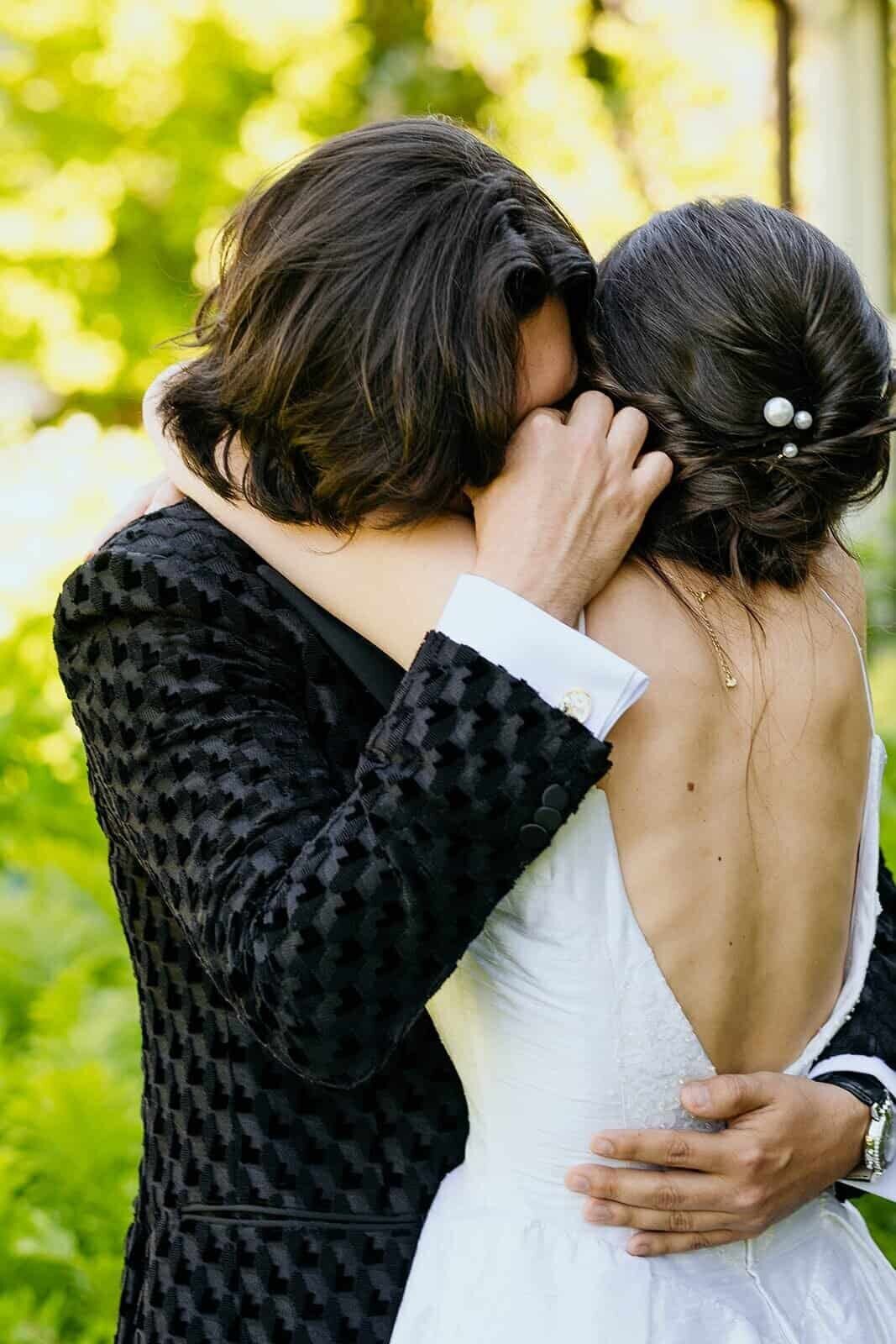 Groom cries as he hugs his new bride