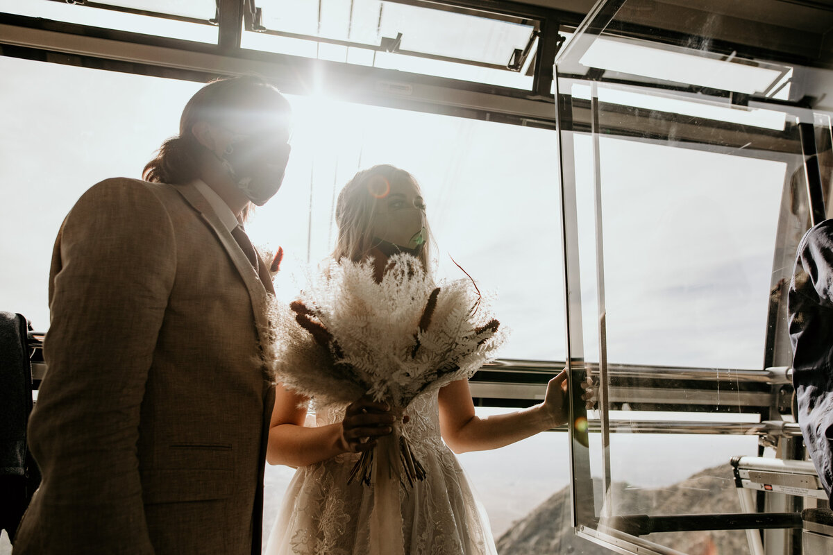 bride and groom riding the sandia peak tram together for their elopement