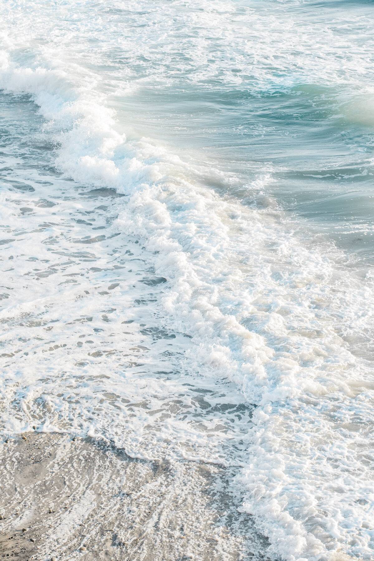 Family Photographer,  beach tides roll onto the sand