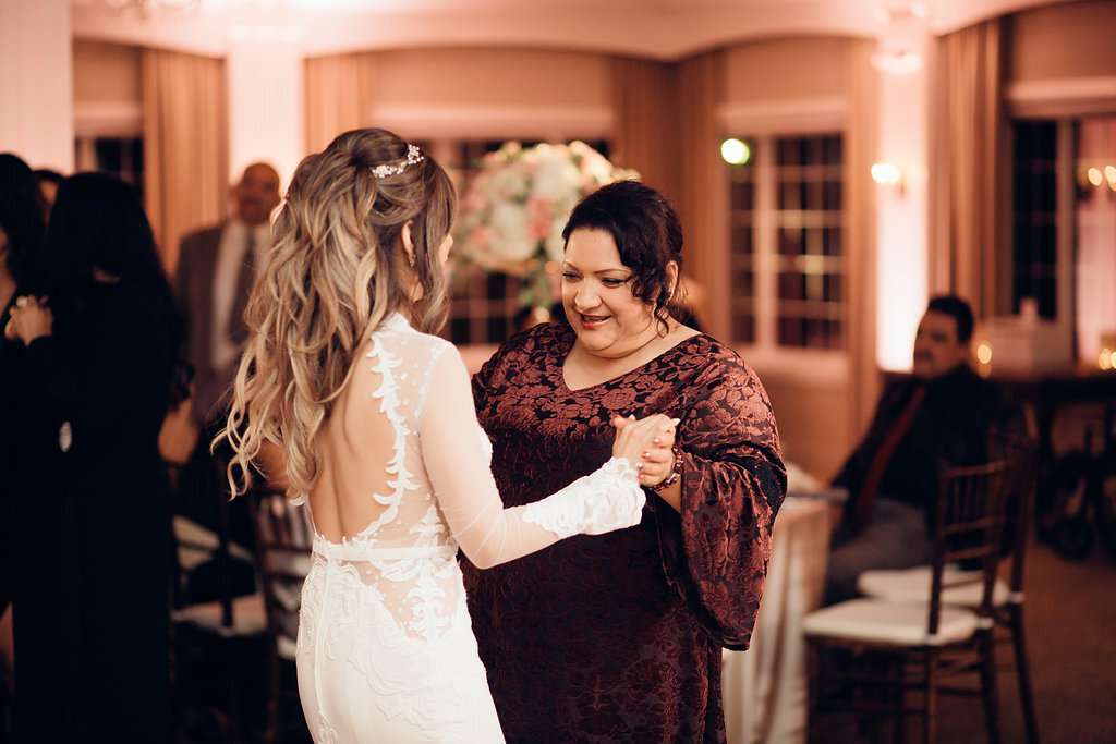 Wedding Photograph Of Bride In White Dress Dancing With a Woman In Maroon Dress Los Angeles