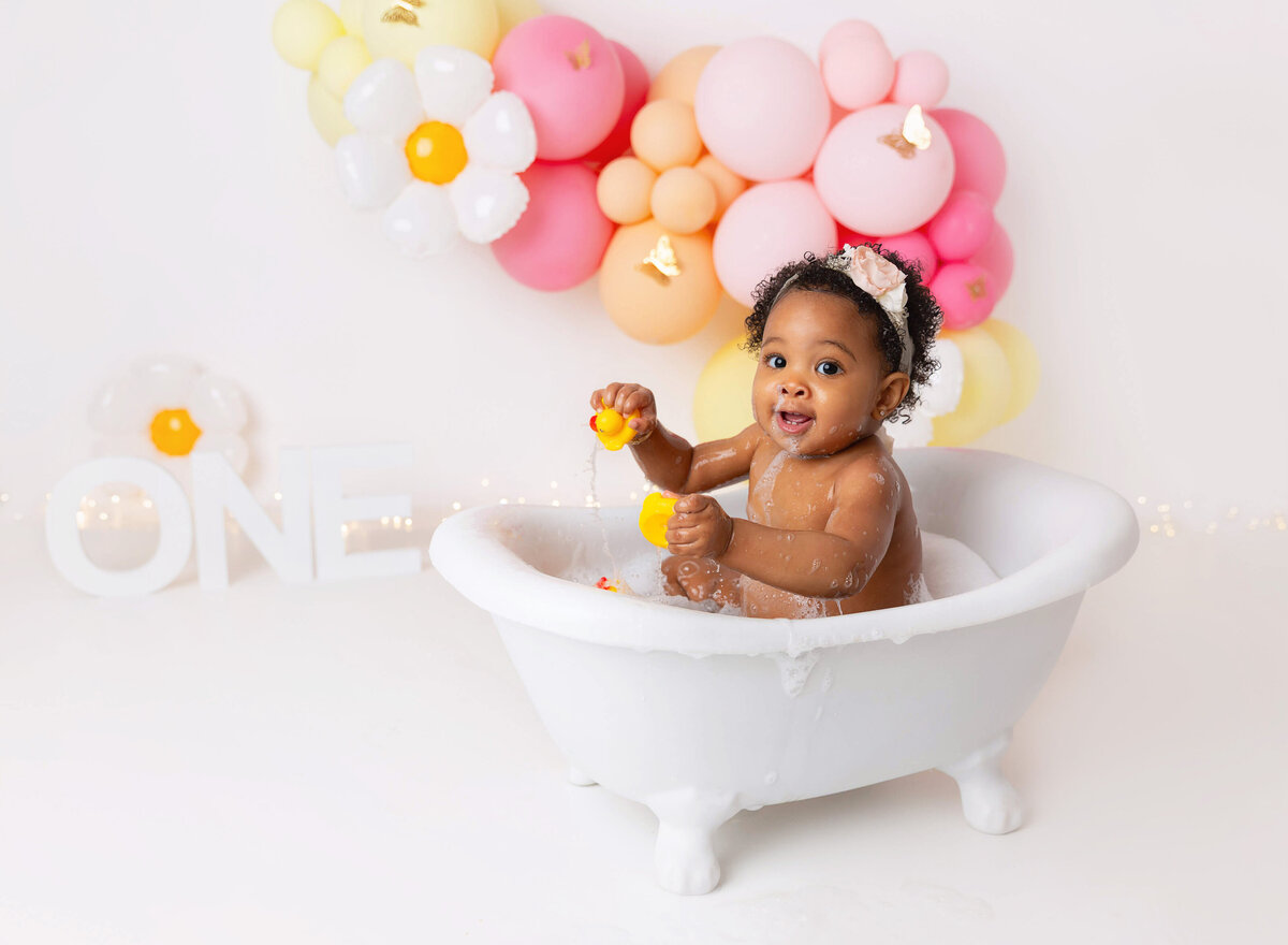 Cake smash pictures done for baby girl daisy theme pink yellow in Brooklyn studio by Rochel Konik Photography
