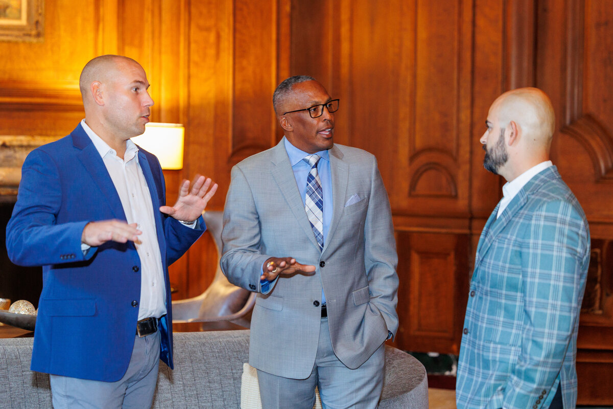 Three males talking at the California Club