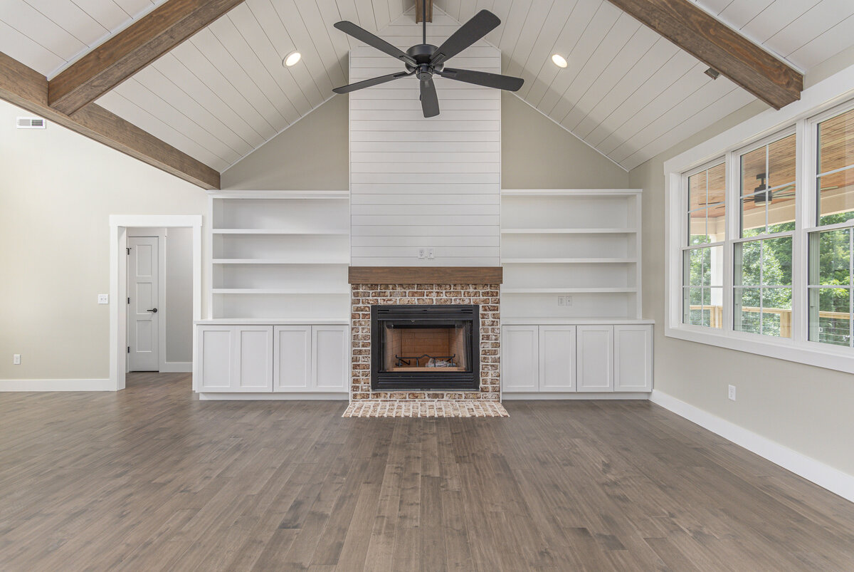 New construction home with hardwood floors and a ceiling fan