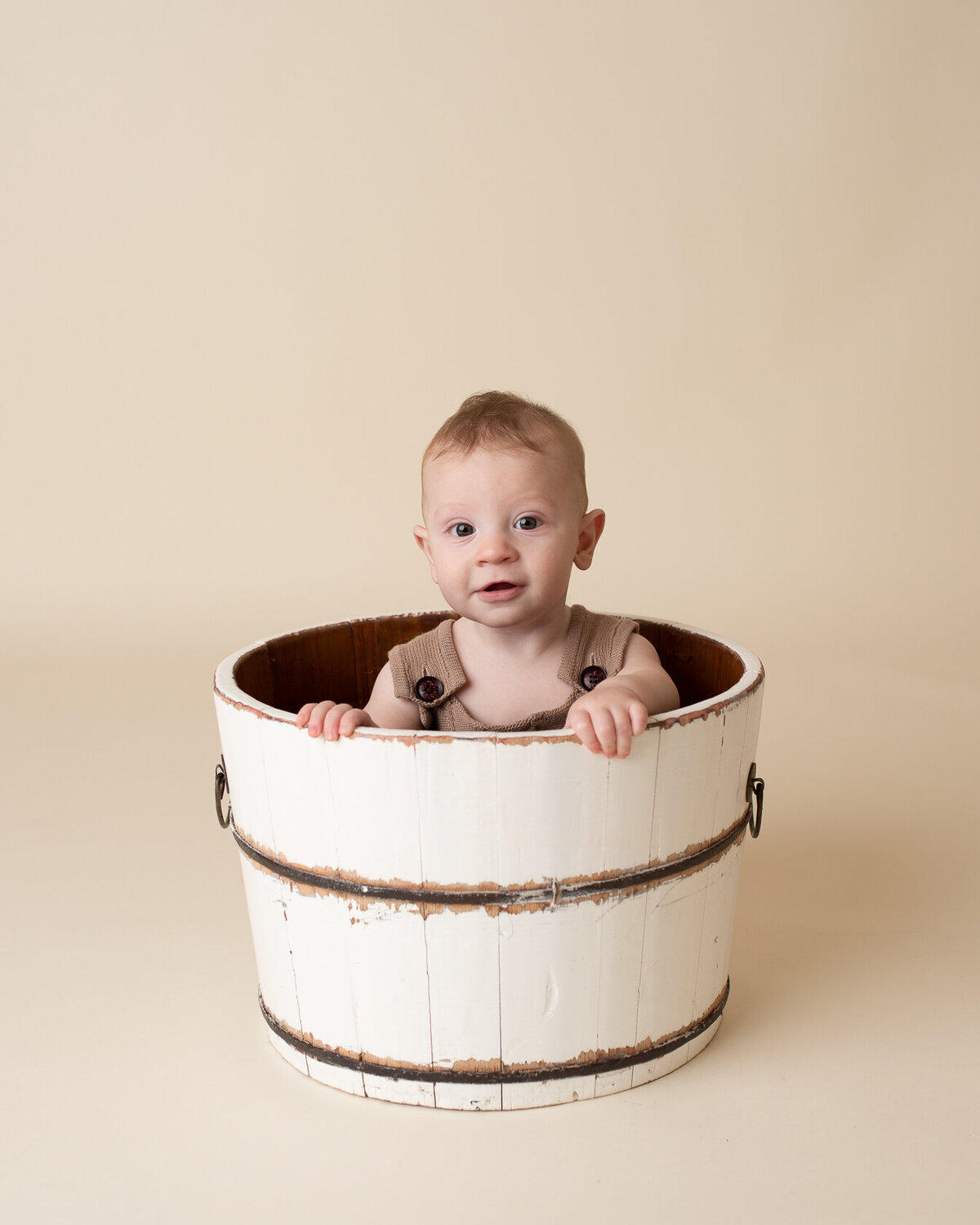 Baby in a bucket photography by Laura King