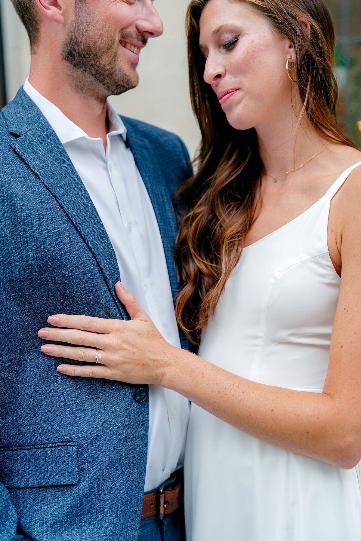 close-up-engagement-ring-on-man-suit