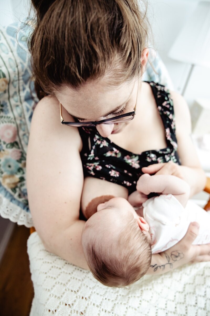 A new mom breastfeeds her two day old baby in her Edmonton home