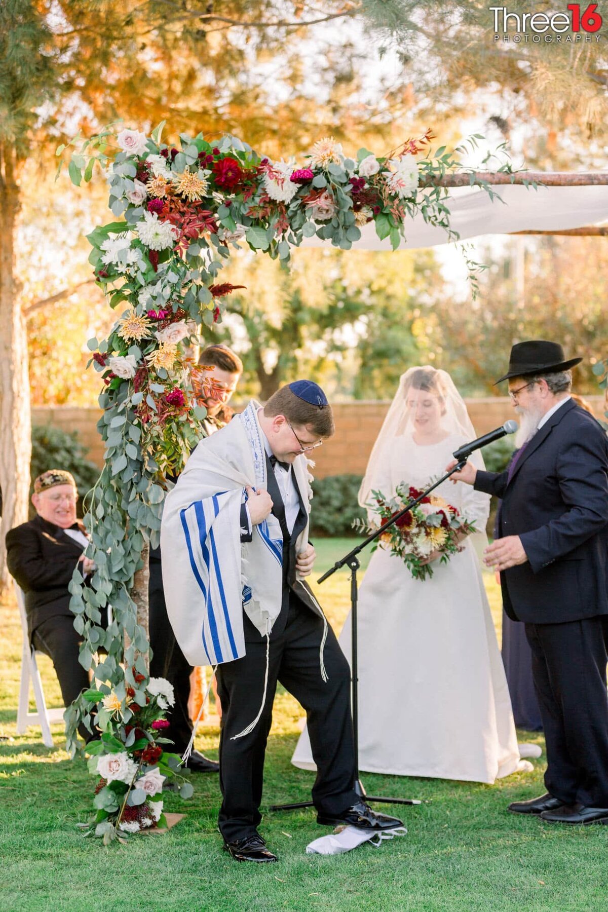Groom stomps on the glass rolled in a napkin as per Jewish custom for good luck