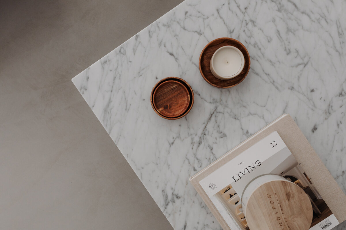kaboompics_minimal-marble-table-with-wooden-candle-holders-and-magazine-37020