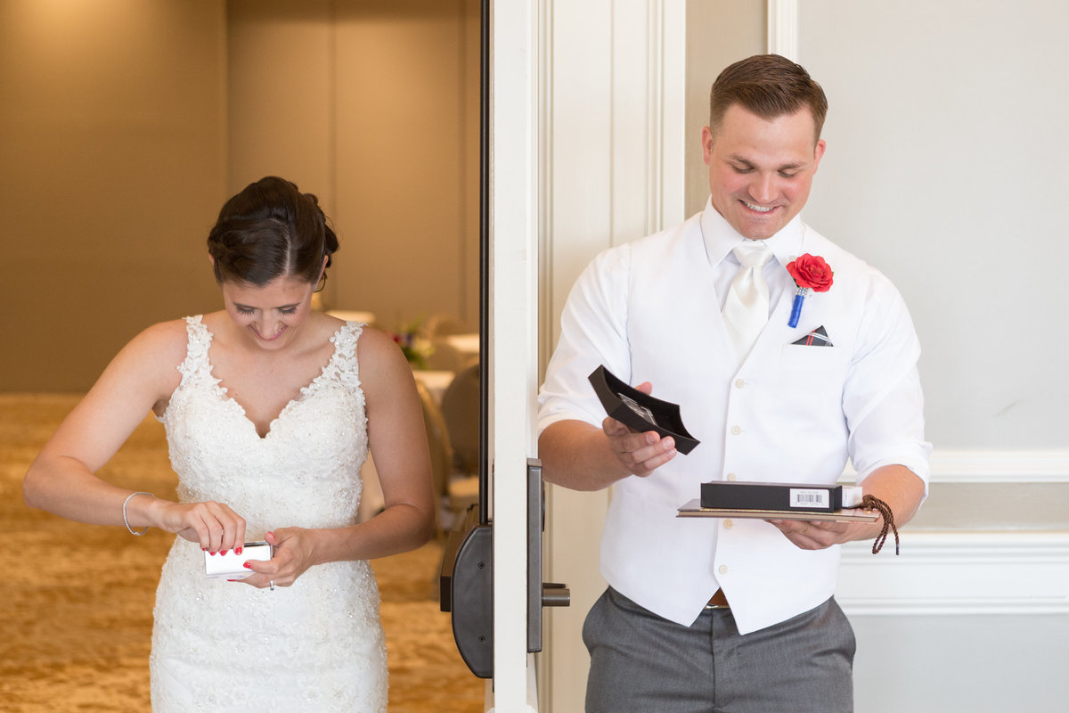 Kristen and Tony Miller open gifts to each other while being separated by a door at The Grand Hotel in Point Clear, Alabama.