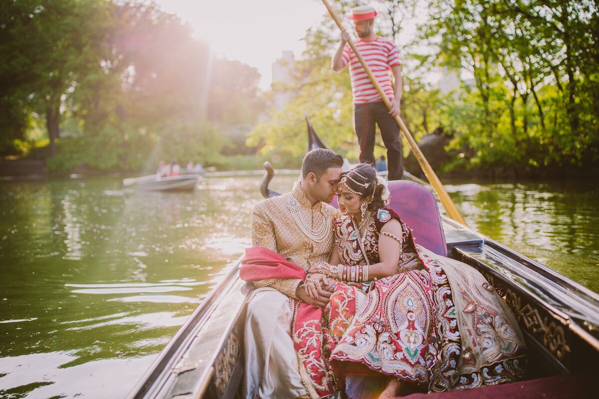 Indian bride and groom enjoying a gondola boat ride in the lake at central park during their wedding