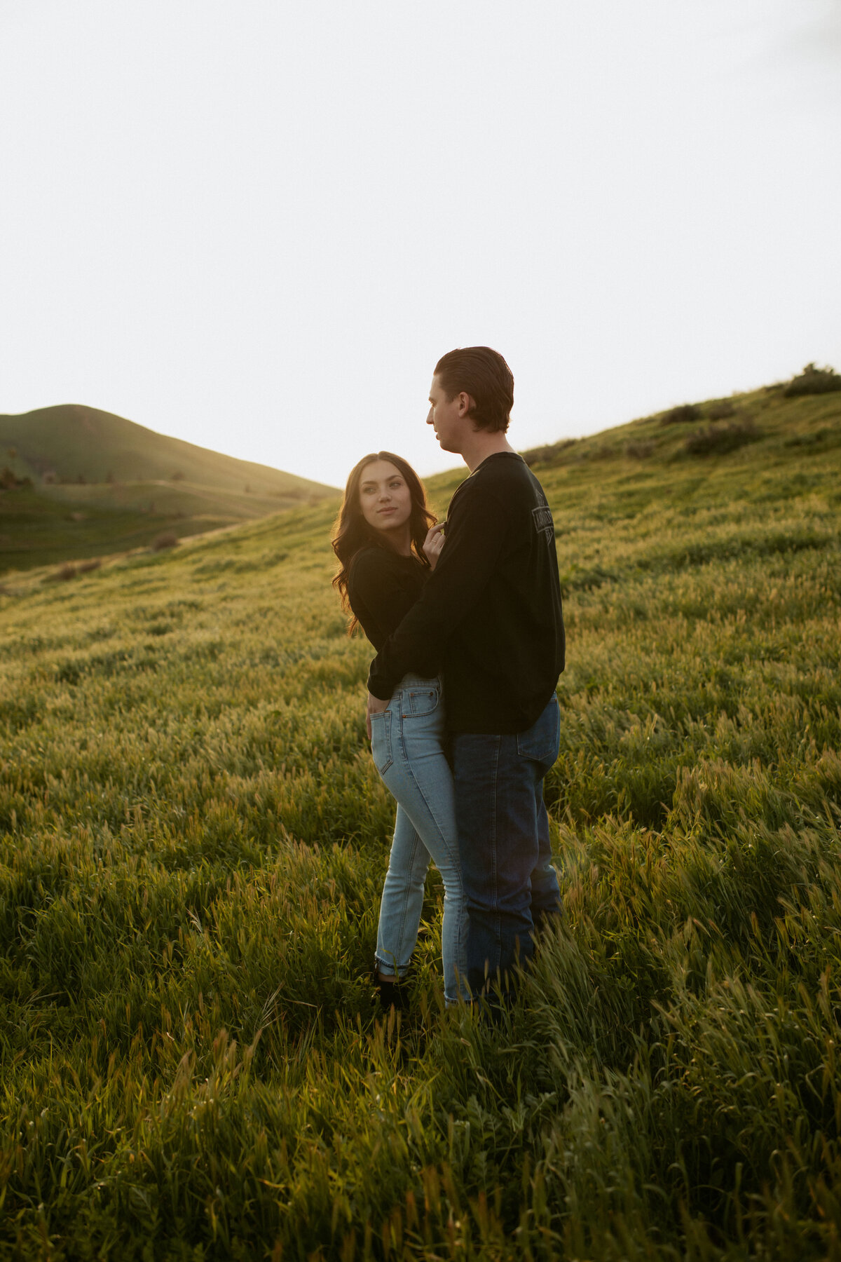 couple standing in green field