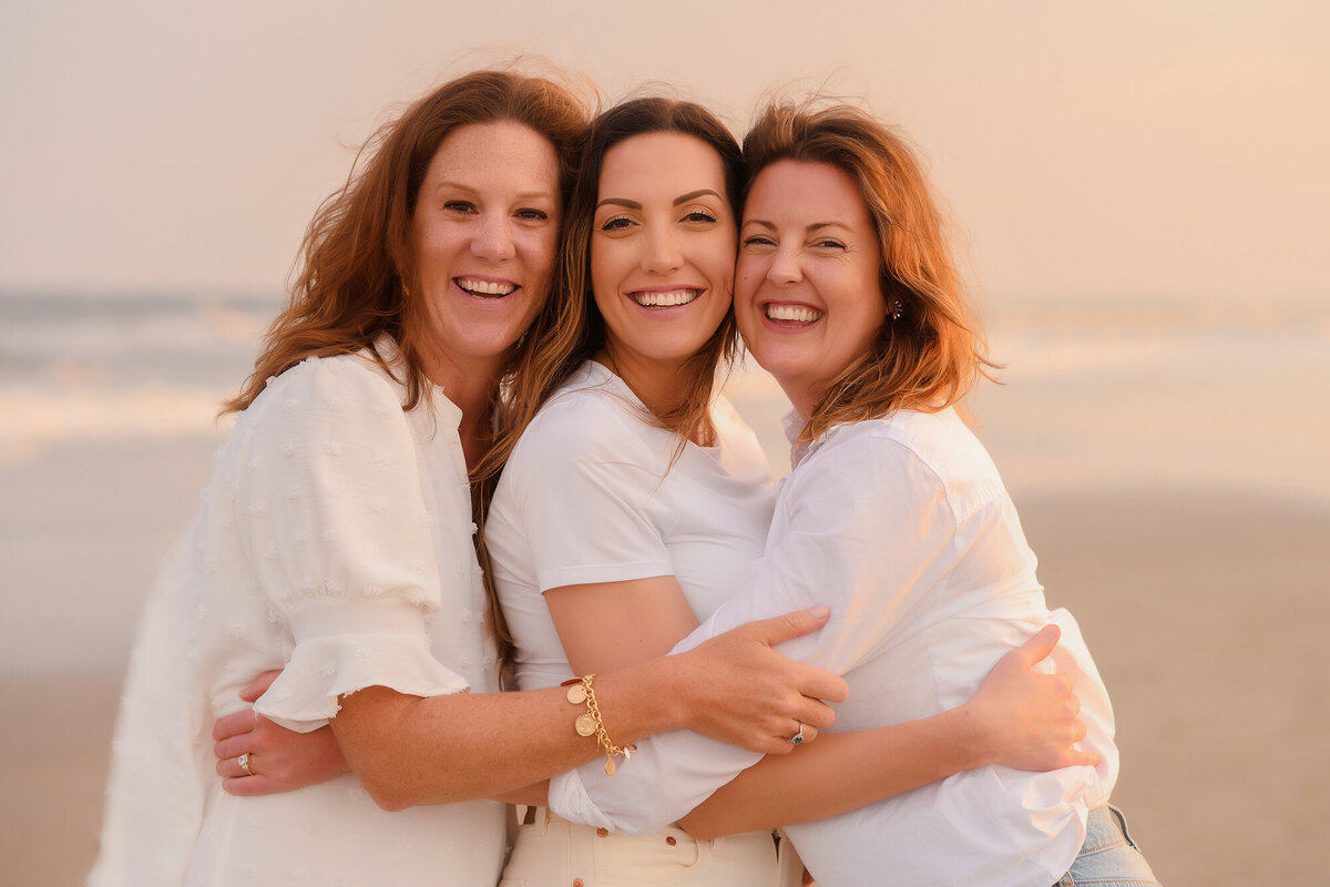 Sisters embrace each other during Family Photoshoot on Isle of Palms. 