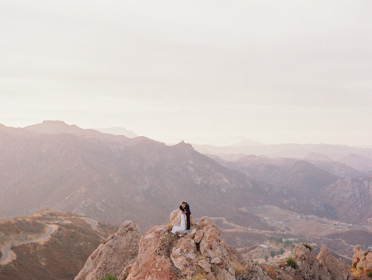 wide shot of couple centered in the middle of moutains at malibu rocky oaks