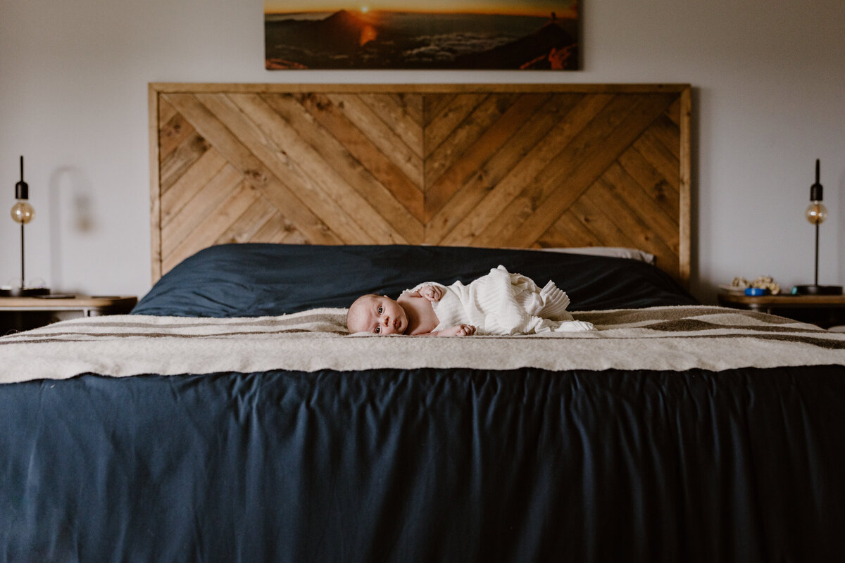 Newborn laying on bed