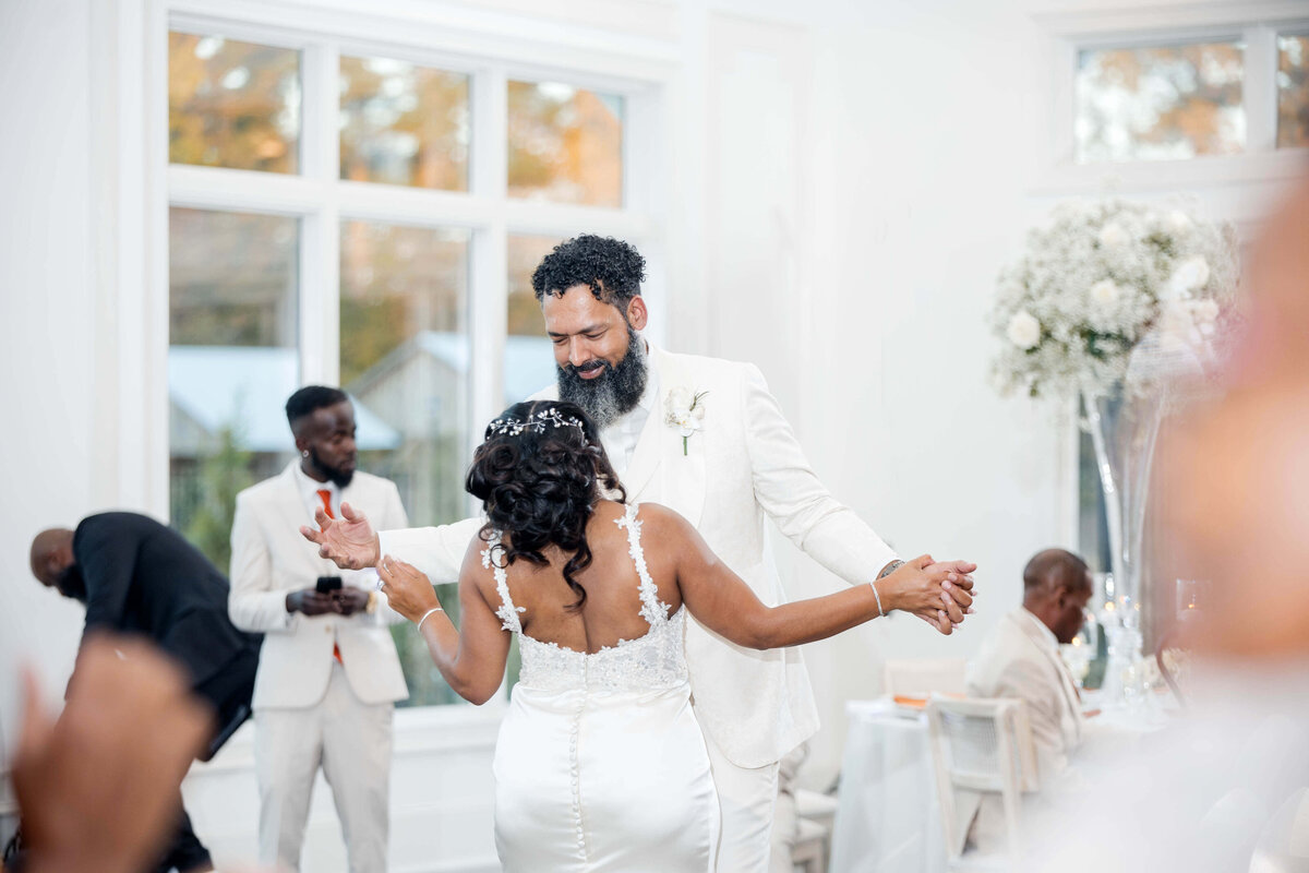 A candid moment of the bride enjoying a fun and energetic celebration on the dance floor.