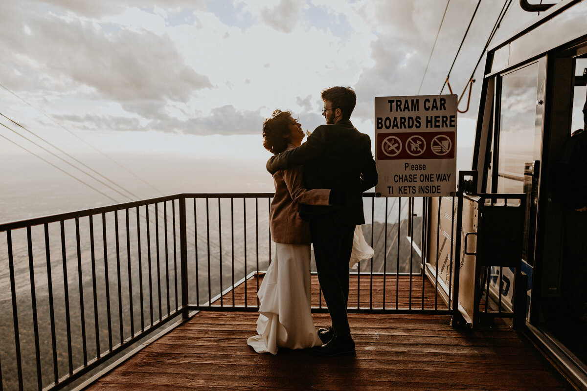 newlyweds taking the tram down from Sandia Peak Tramway after ceremony