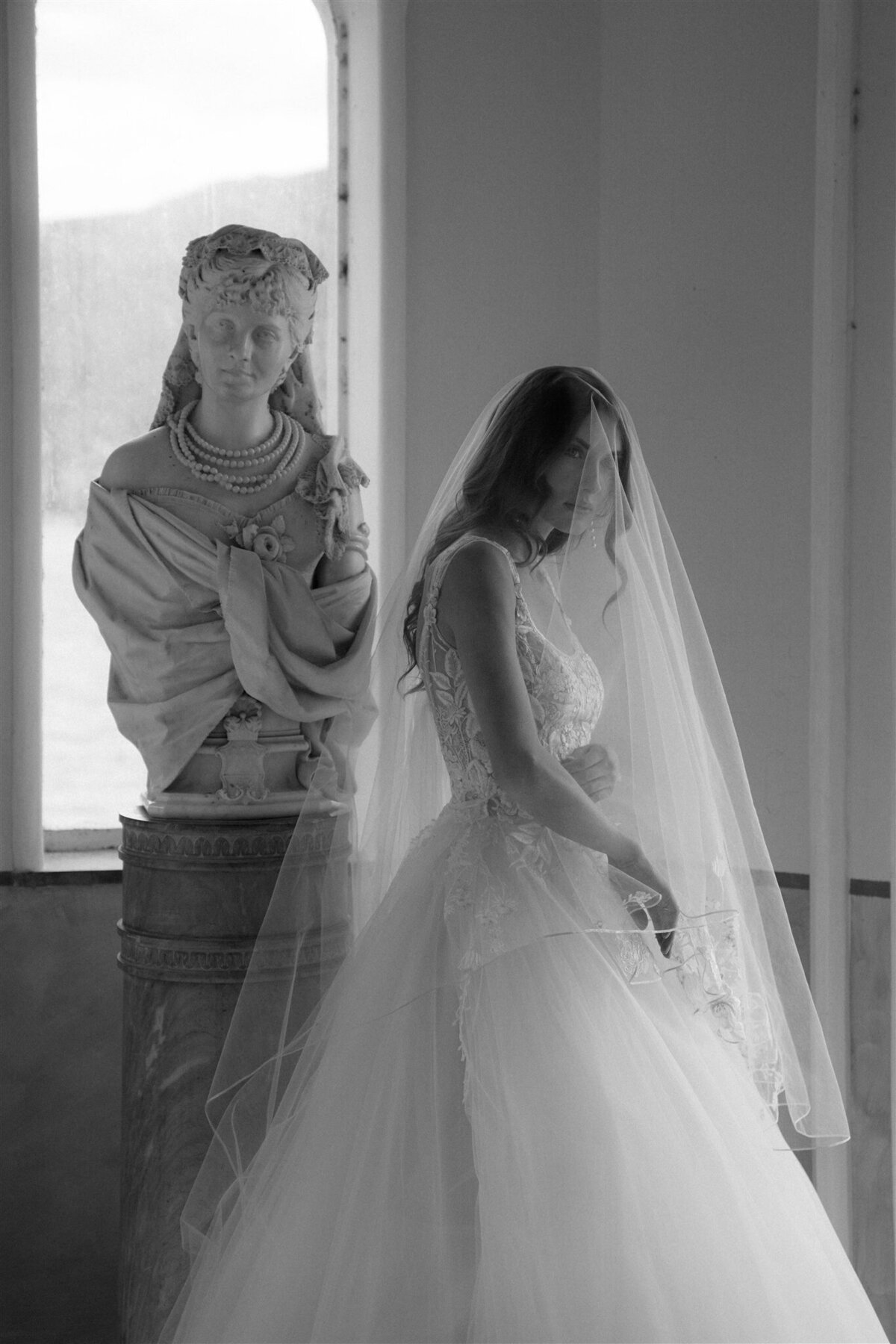 bride standing next to statue in nice france after eloping