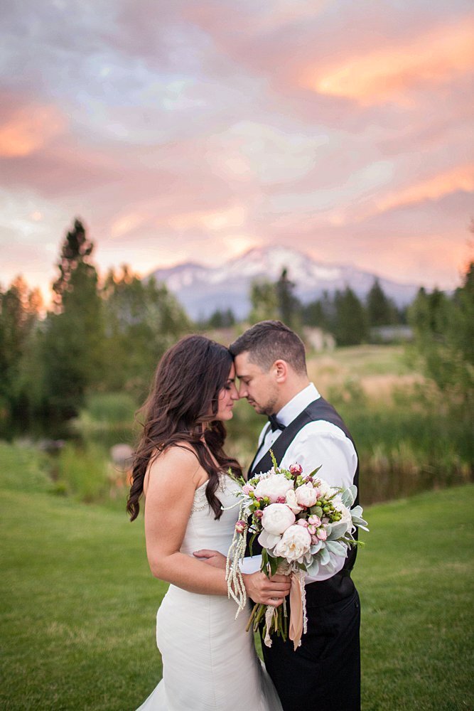Summer newlyweds with vibrant sunset mountain view