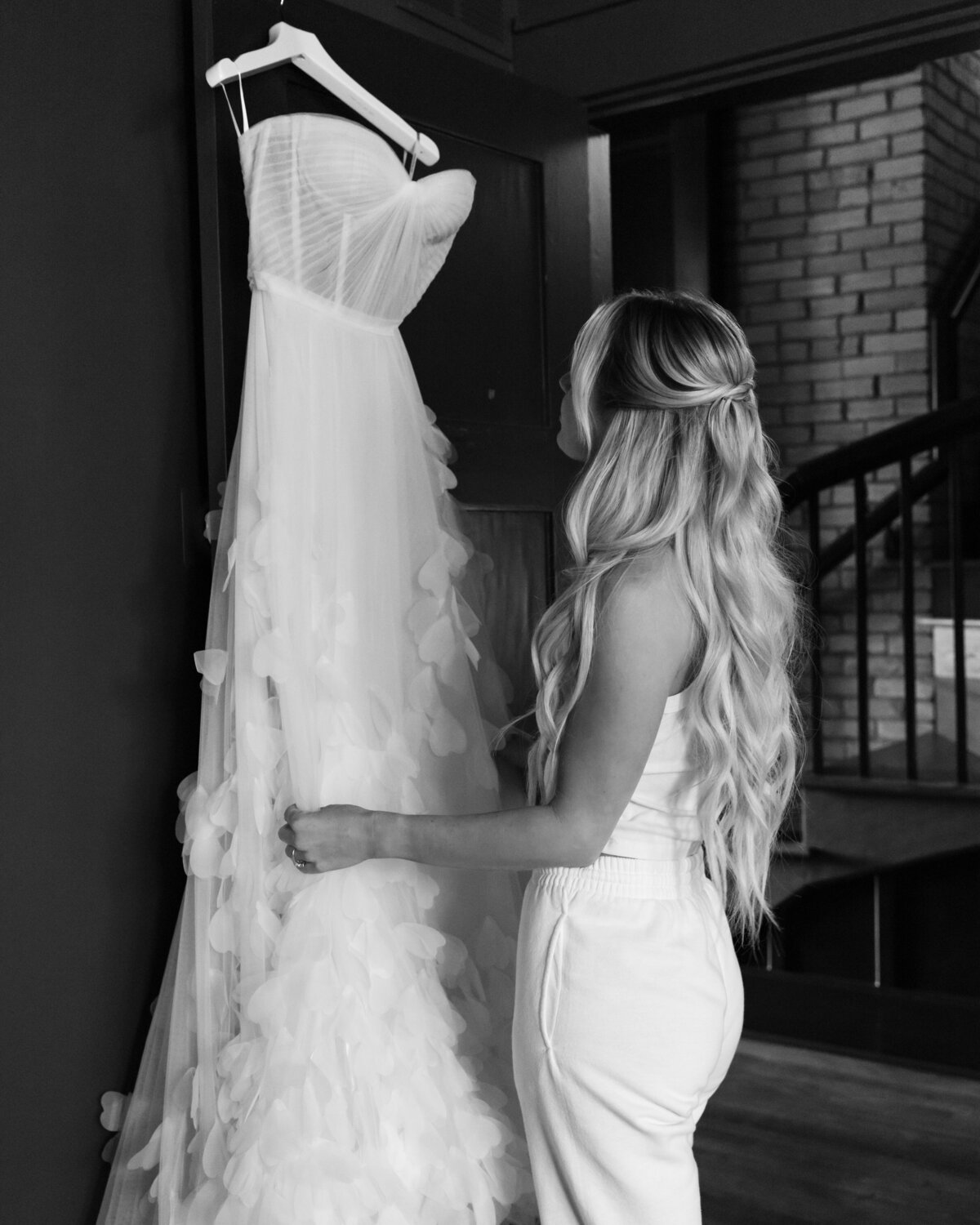 bride looking at wedding dress for photographer