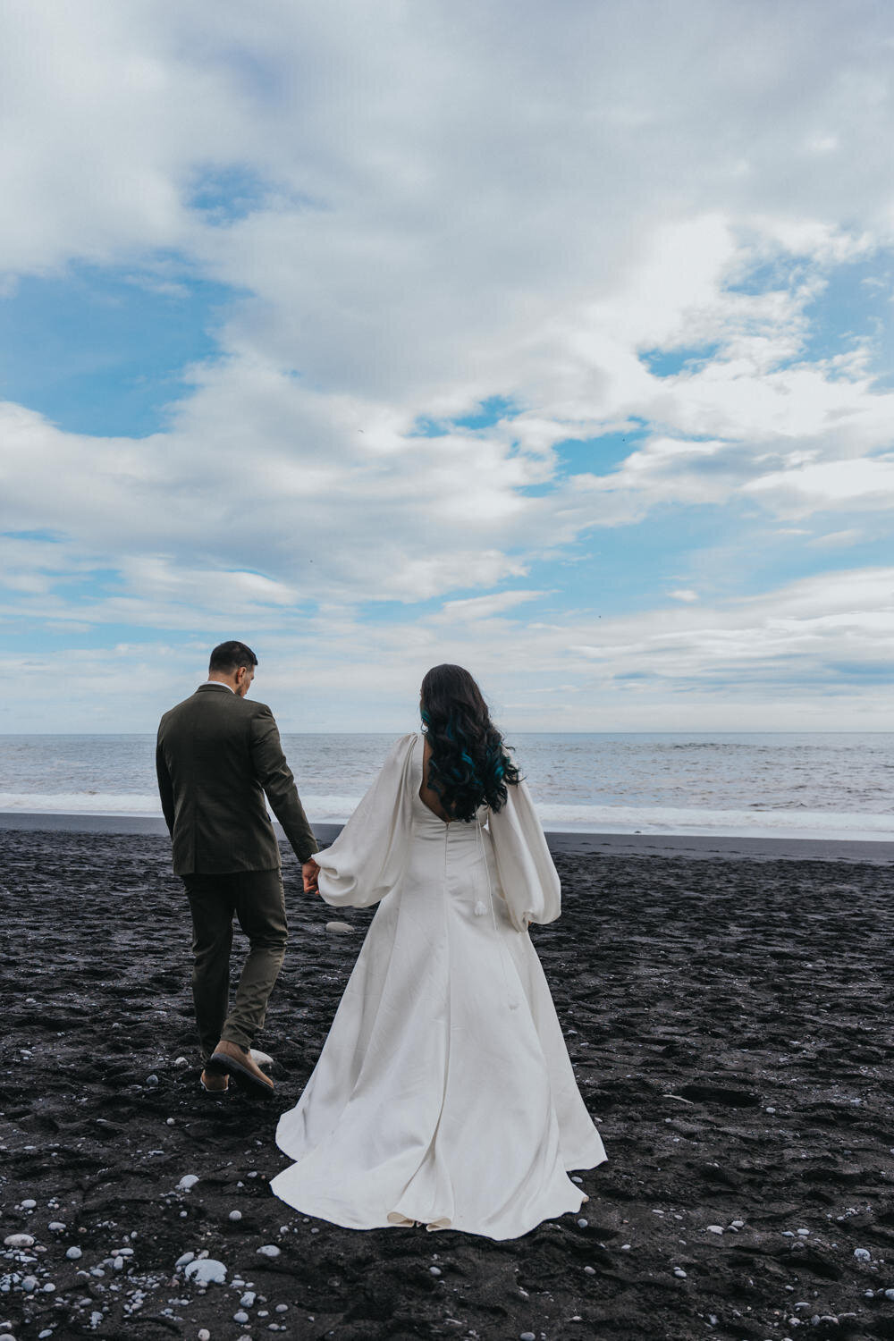 Husband and wife walk down the Black Sand Beaches 