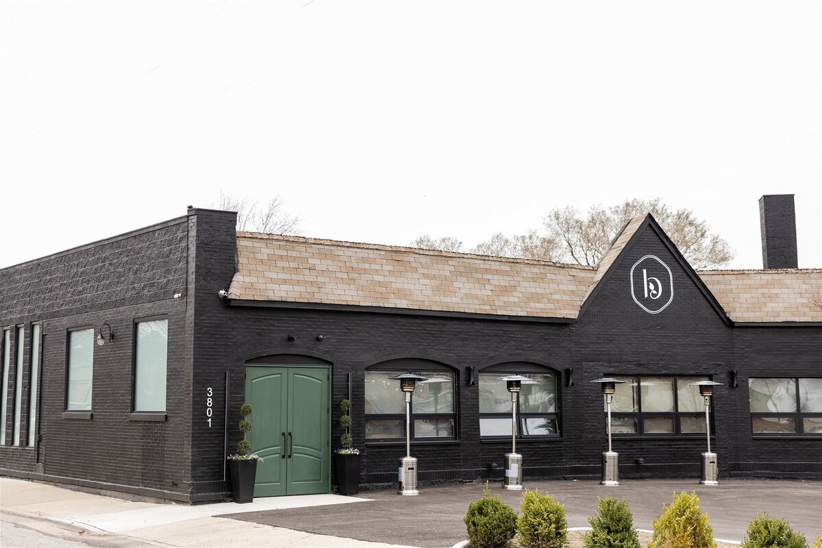 Elegant exterior of a luxury event venue with iconic entrance doors, accessible entrance, driving and parking, exterior showing natural lighting