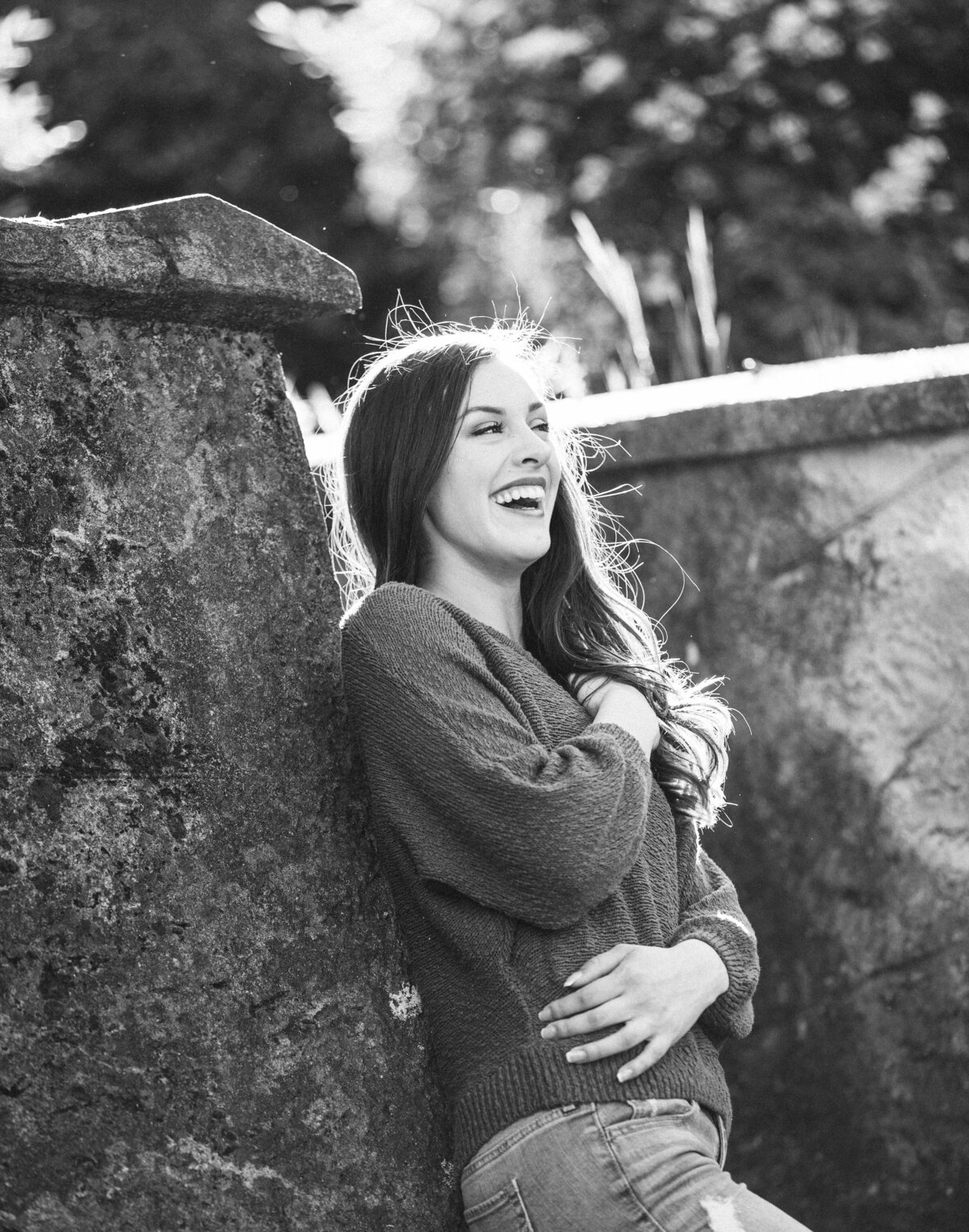 Black and white senior picture of a girl laughing in Los Gatos