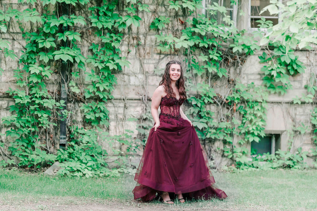 A girl lifts up the skirt of her dress to show off her shoes. 