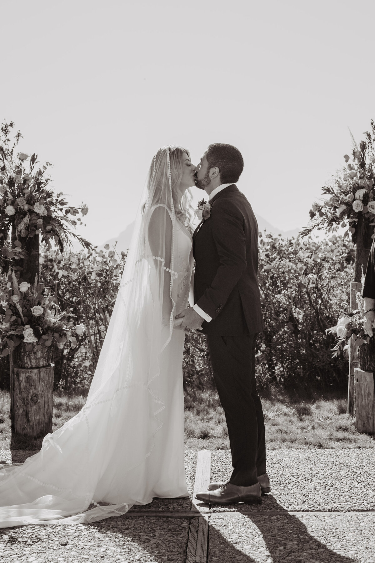 Photographers Jackson Hole capture bride and groom kissing as husband and wife