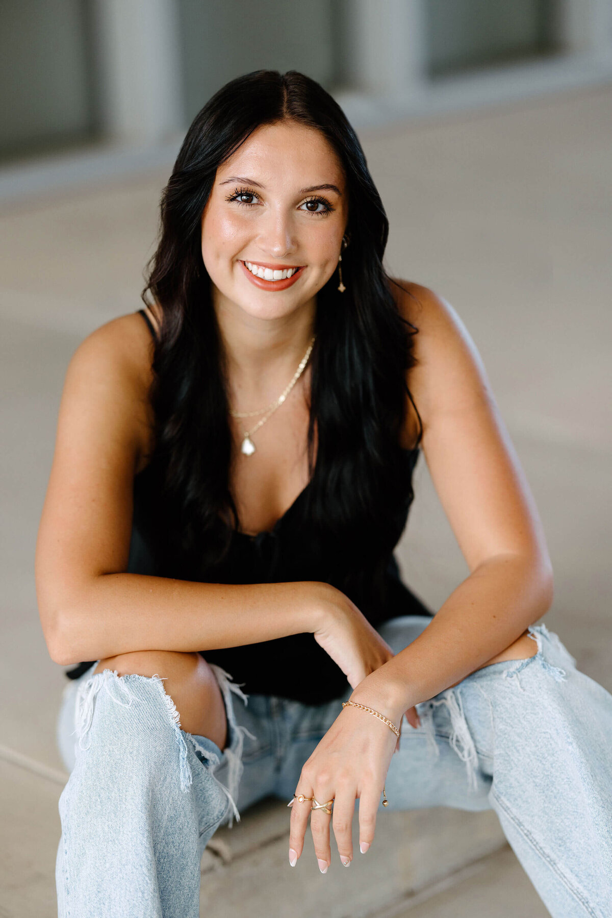 Hallsville High School 2026 graduate in black sleeveless top and bluejeans posing for senior pictures in Longview, Texas