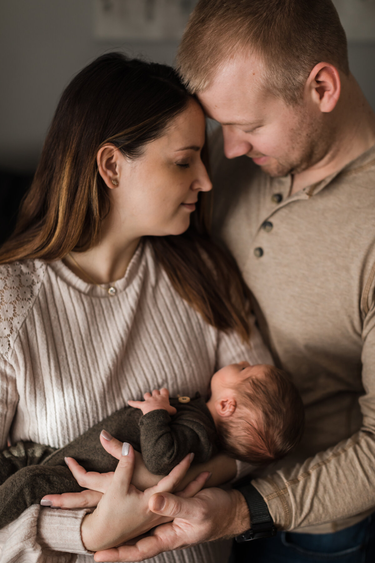 mom and dad holding newborn son for in home lifestyle session
