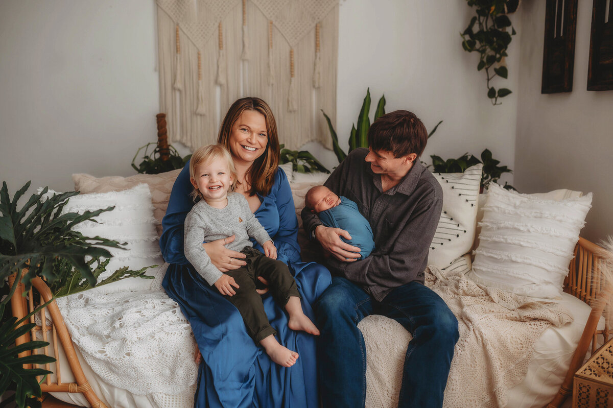 Family poses for Newborn Portraits in Charleston.