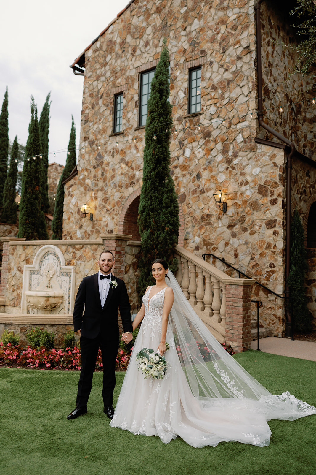 bride and groom in garden at bella collina weddings & events​