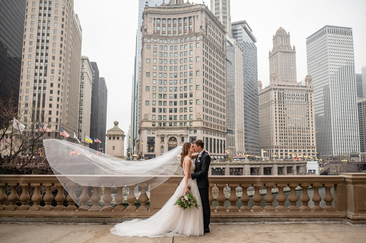 A wedding veil flies in the air  while on the Chicago Riverwalk in winter