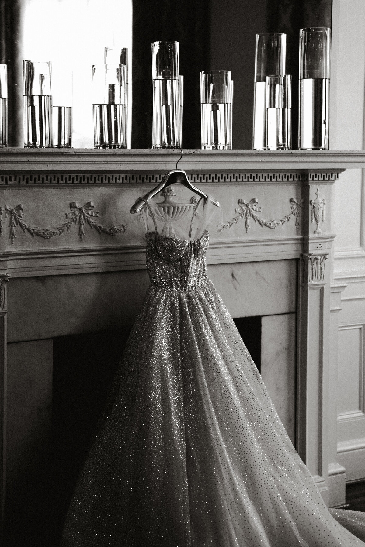 Wedding gown hanging on fireplace at The Hotel Concord.
