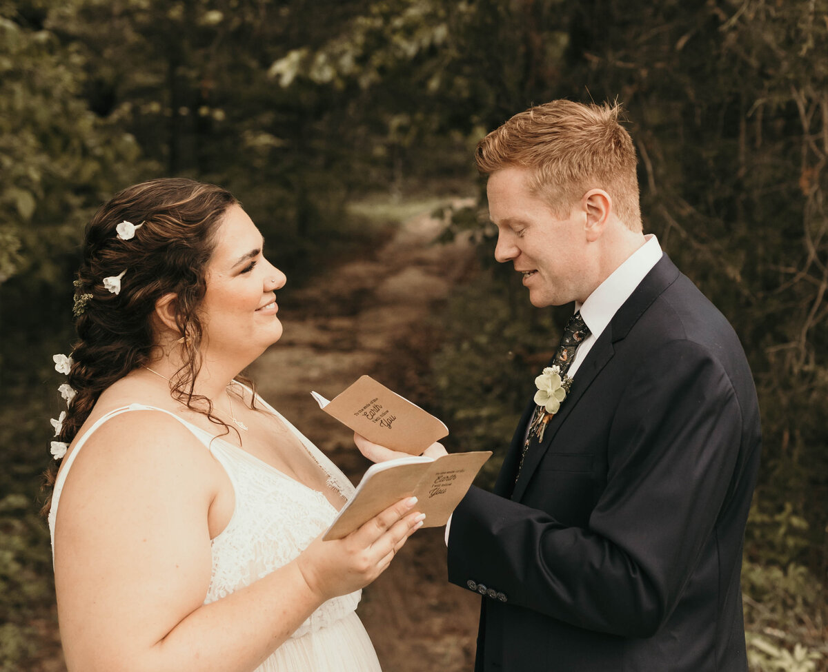 close up of couple reading vows at a woods elopement