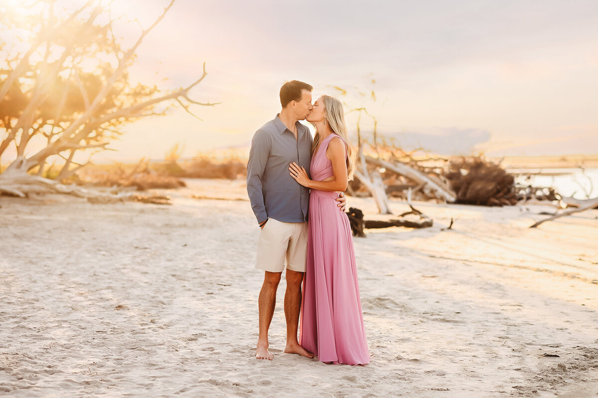 Couple shares a kiss during Family Portraits on Folly Beach. 
